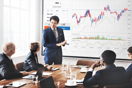 Experts discussing SIP investment strategies with stock market charts