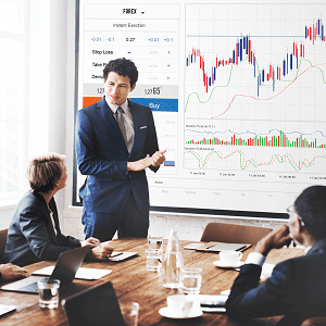 Experts discussing SIP investment strategies with stock market charts